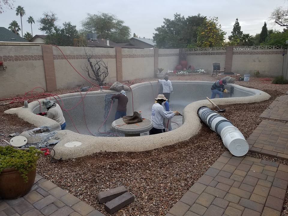 Attached image file Pool resurfacing crew preparing a residential swimming pool for a new finish in Mesa, AZ