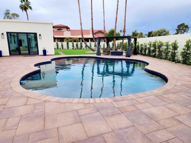 Completed pool resurfacing with a dark pebble finish and updated backyard deck