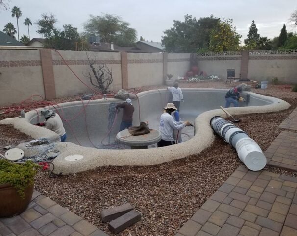 profession renovation team working on resurfacing a pool